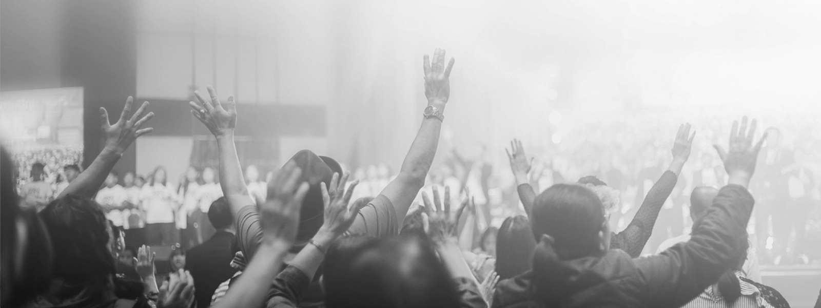 A congregation lifting their hands in praise